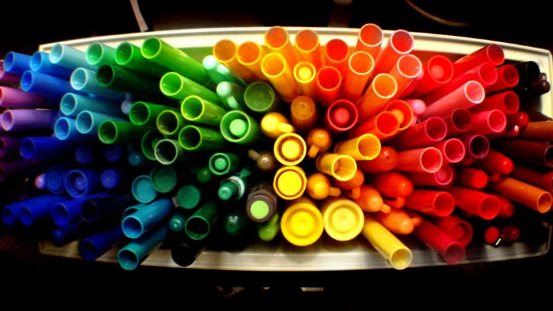markers organized by color to be a rainbow