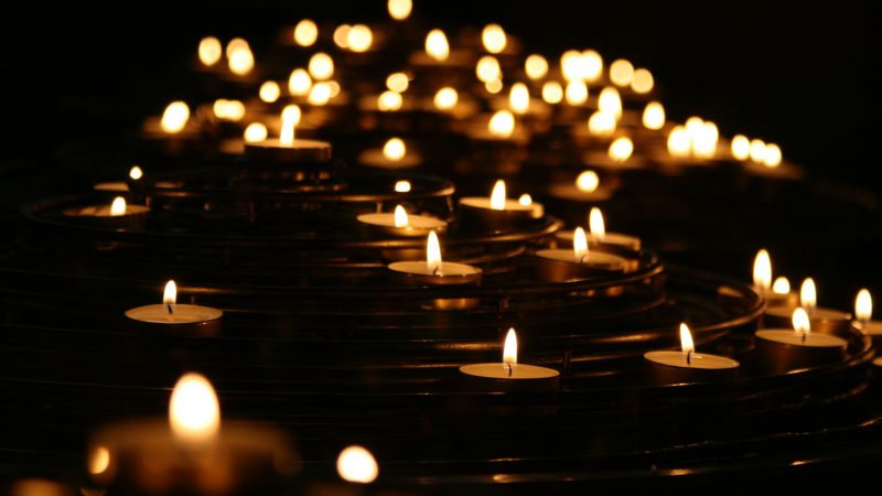 Lit candles in the darkness