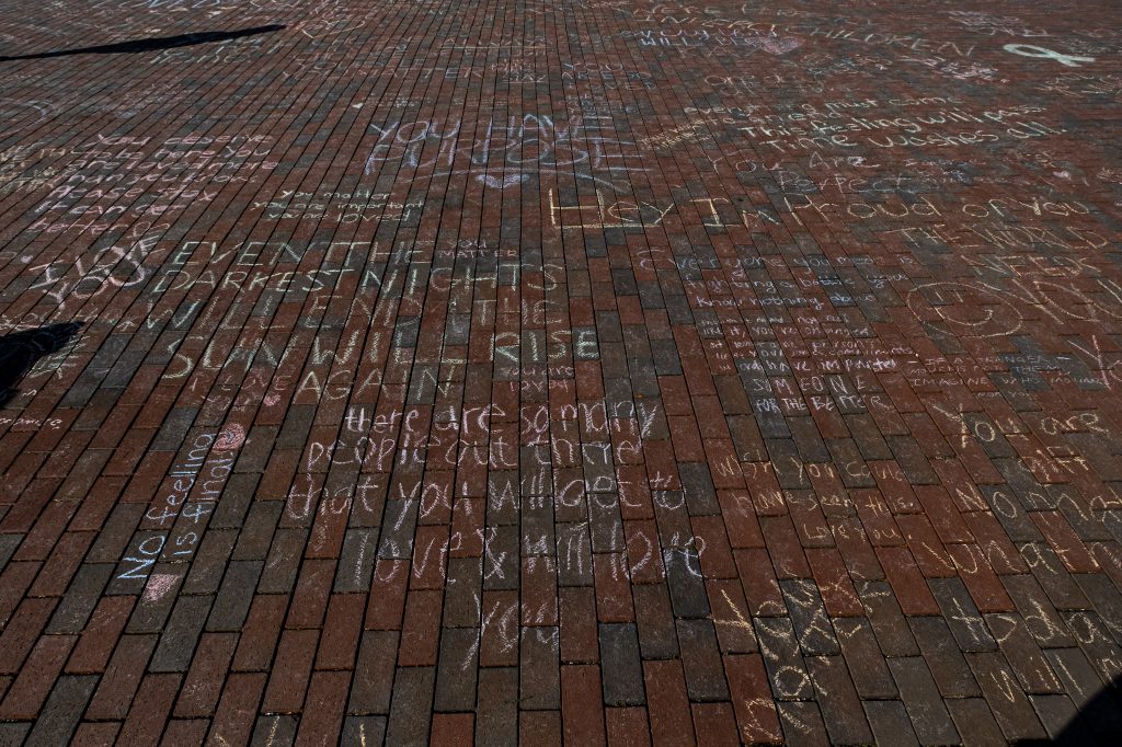 Uplifting messages supporting mental health in chalk around UNC campus