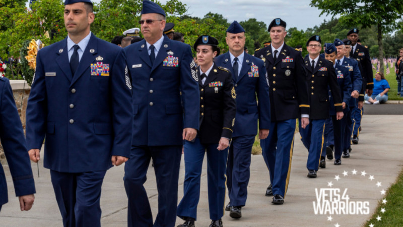People in military uniforms walk in a line