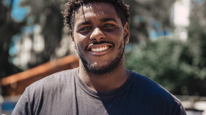 black man smiles at camera