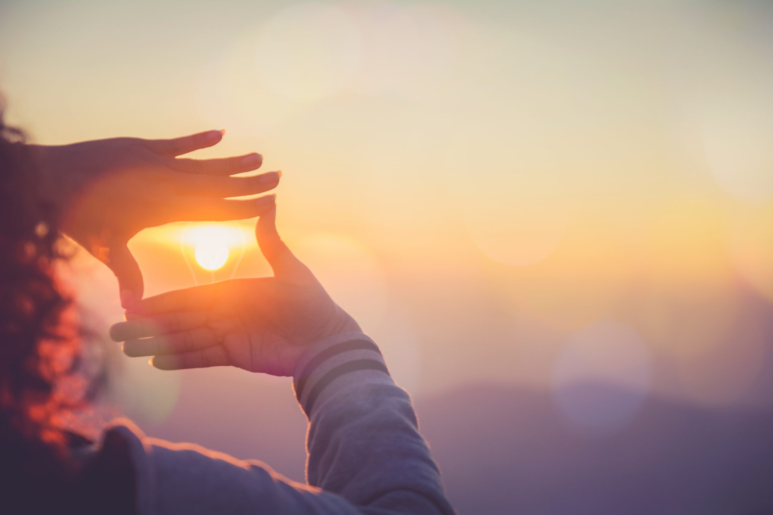 frame round the sun with hands in sunrise